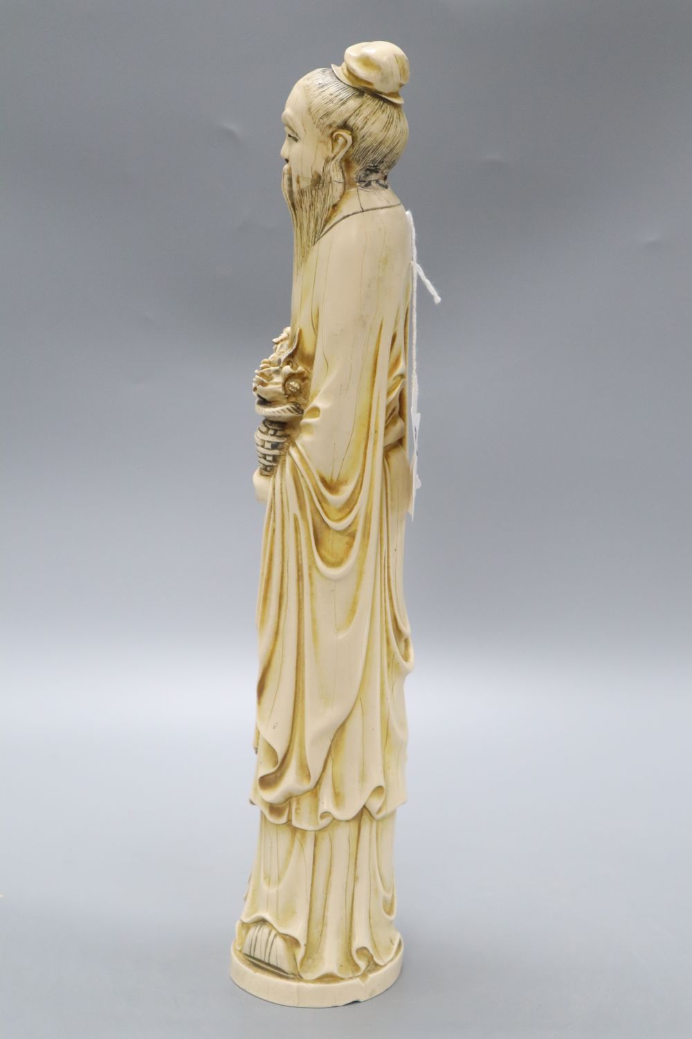 A Chinese simulated ivory figure of an elder, height 37cm